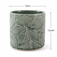 Forest Vein Ceramic Planter Its clean cylindrical shape offers a balanced and versatile silhouette that works beautifully in both contemporary and traditional interiors. The softly glazed rim and earthy colour palette make it especially suitable for white or pastel Phalaenopsis orchids, while also complementing foliage plants, succulents and artificial arrangements. Compact yet visually distinctive, this planter is ideal for dining tables, office desks, reception counters, shelves and thoughtful gift presentations. Product Details Product: Decorative ceramic planter Colour: Sage green with ivory leaf detailing Diameter: Approximately 14cm Height: Approximately 13cm Cylindrical shape Raised botanical leaf pattern Detailed dotted texture Suitable for orchids, foliage plants, succulents and decorative arrangements Plant and arrangement accessories are not included Measurements are approximate, and slight variations in colour or finish may occur.